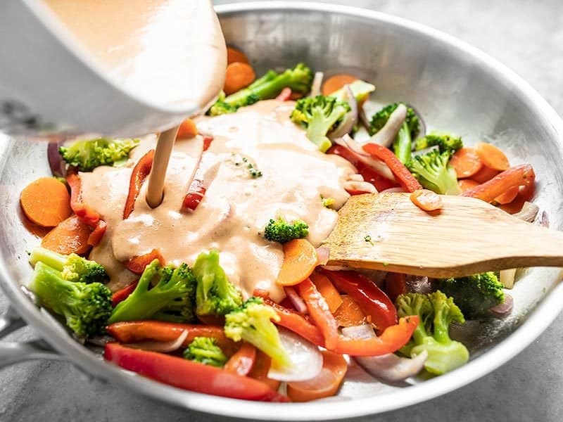 Ajouter de la sauce épicée à la noix de coco aux légumes sautés