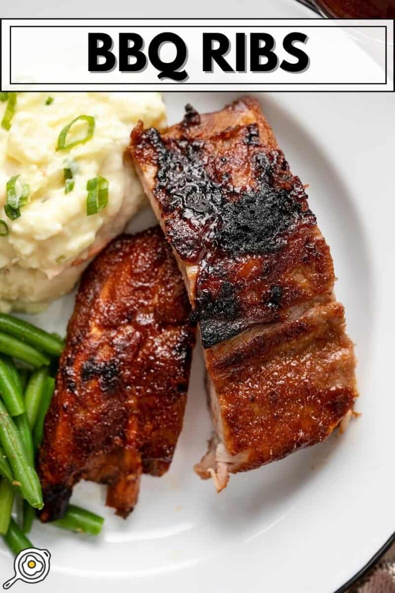 Couper les côtes levées sur une assiette blanche avec de la purée de pommes de terre et des haricots verts.
