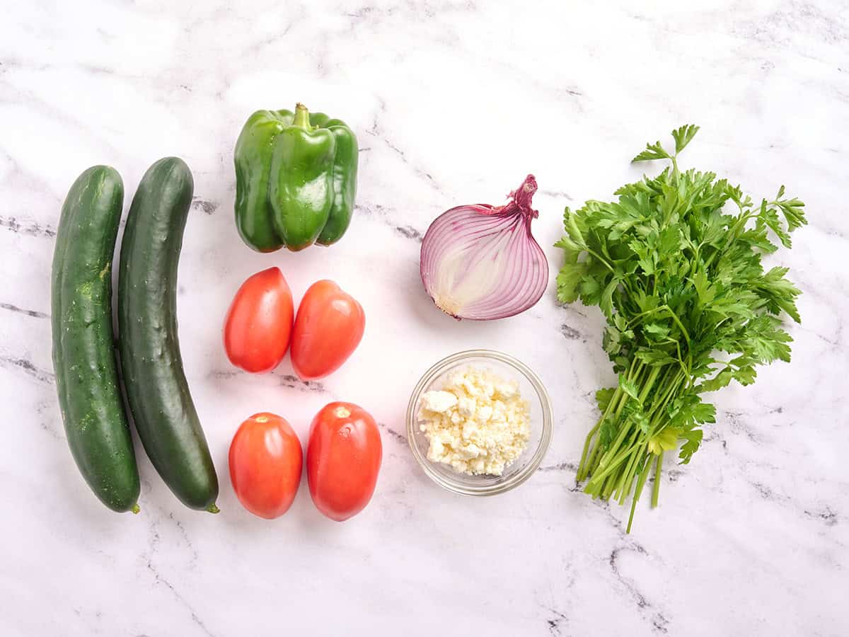 Les ingrédients frais pour faire une salade de concombre et de tomates.