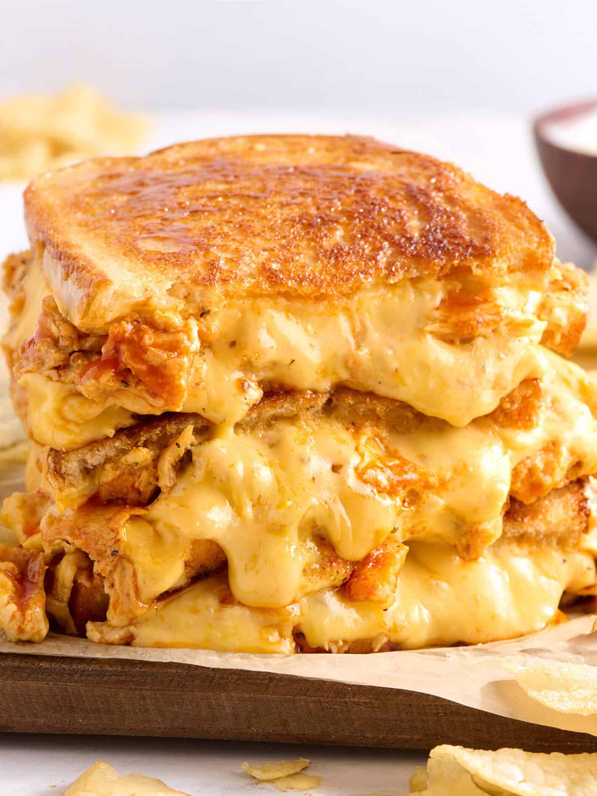 Vue latérale d'une pile de sandwichs au fromage grillé au poulet Buffalo.